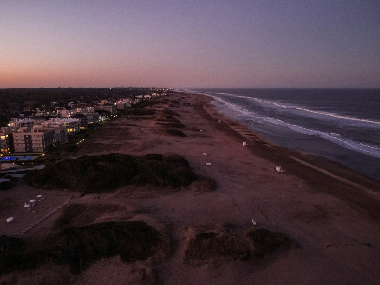 an aerial view of a beach at dusk