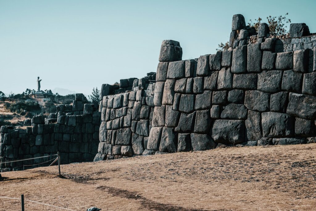 a stone wall with a cross on top of it