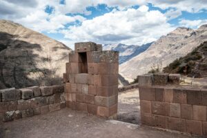 a view of a mountain range from a stone wall